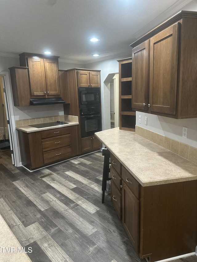 kitchen featuring black appliances, ornamental molding, open shelves, and dark wood-type flooring