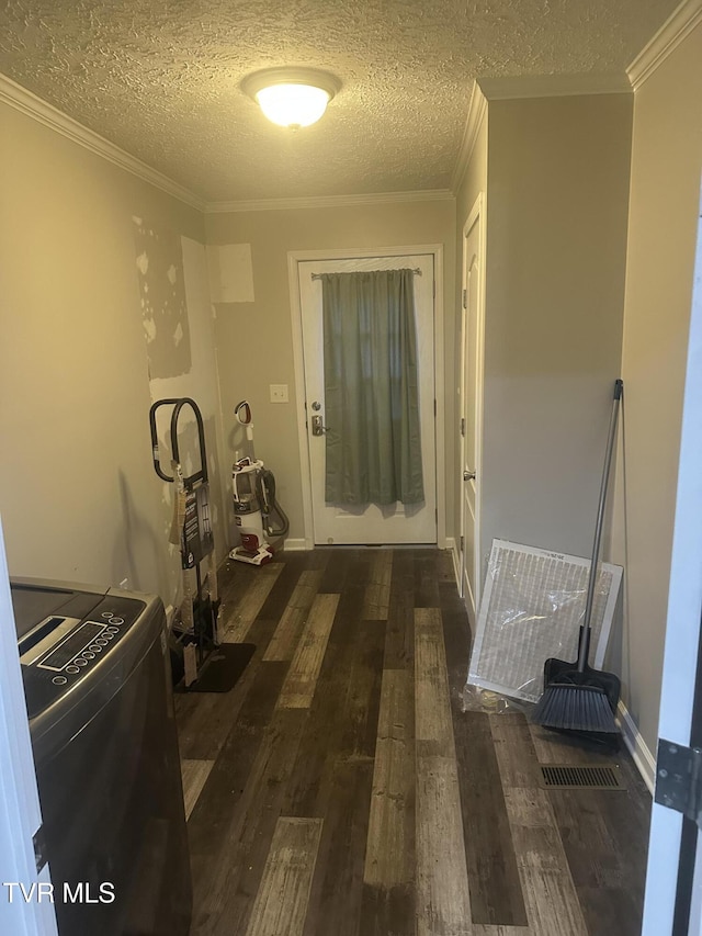 hall featuring washer / dryer, baseboards, ornamental molding, wood finished floors, and a textured ceiling