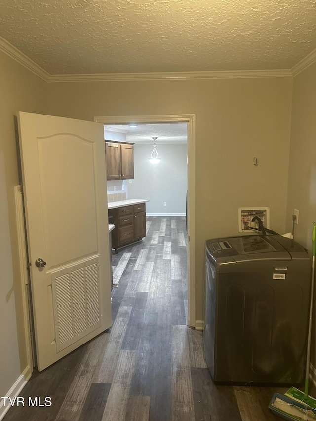 laundry area with dark wood-style floors, crown molding, visible vents, washer / dryer, and laundry area