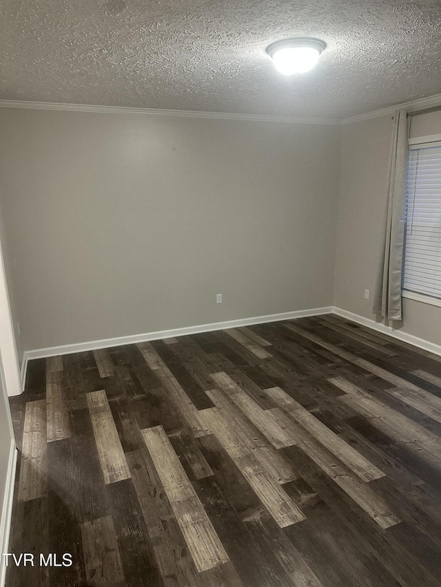 unfurnished room with ornamental molding, dark wood-style flooring, a textured ceiling, and baseboards