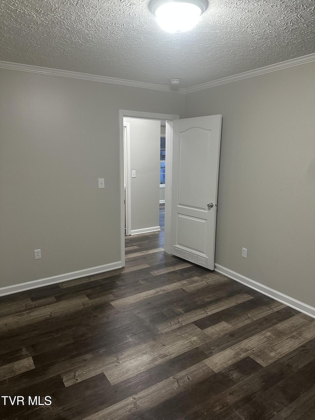 unfurnished room featuring ornamental molding, dark wood finished floors, and a textured ceiling