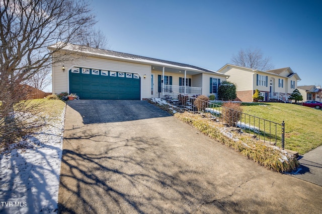 ranch-style house with driveway, covered porch, a garage, and a front yard