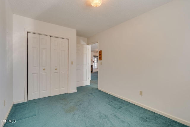 unfurnished bedroom with carpet floors, a closet, baseboards, and a textured ceiling