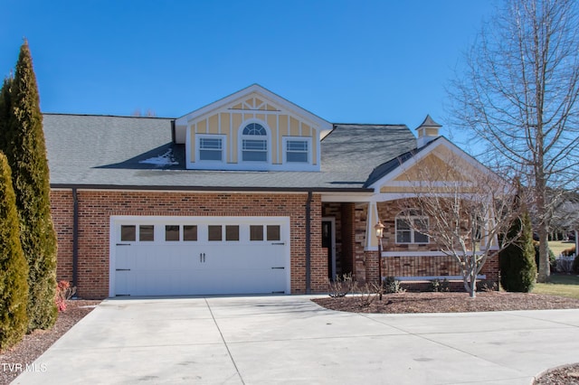 view of front of property featuring a garage, concrete driveway, and brick siding