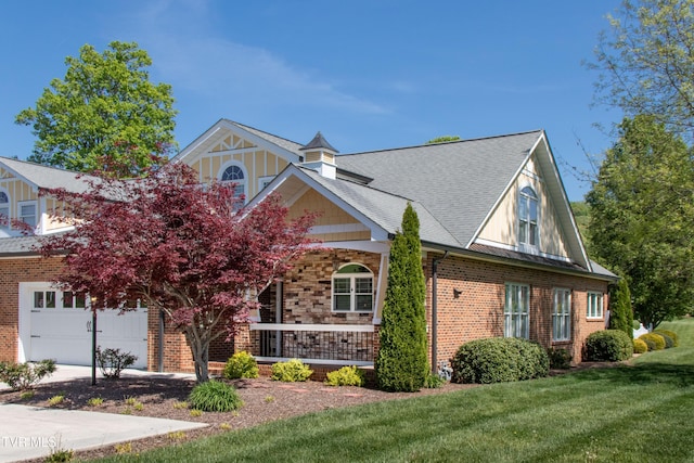 view of front of house with a porch, a front yard, a garage, a shingled roof, and brick siding