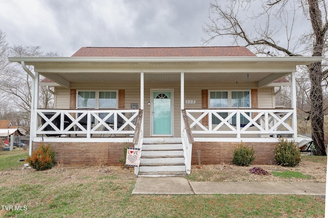 bungalow-style house featuring a porch and roof with shingles