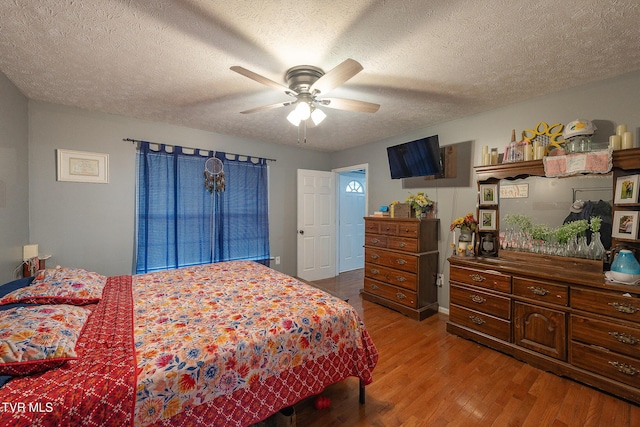 bedroom featuring a textured ceiling and wood finished floors