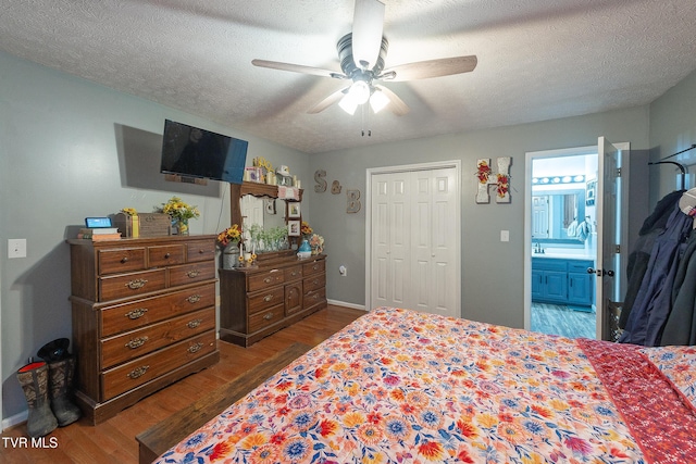 bedroom featuring a textured ceiling, a ceiling fan, and dark wood-style flooring