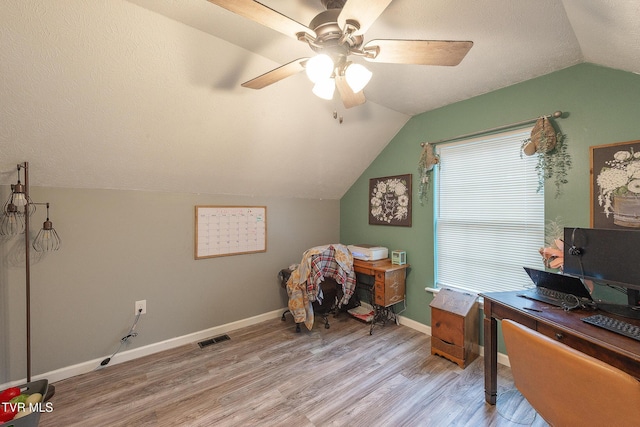 office with lofted ceiling, visible vents, light wood-style flooring, a textured ceiling, and baseboards