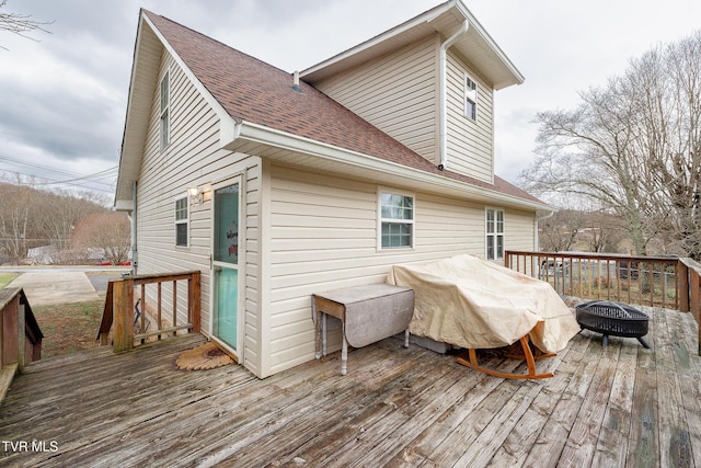 deck with a grill and a fire pit