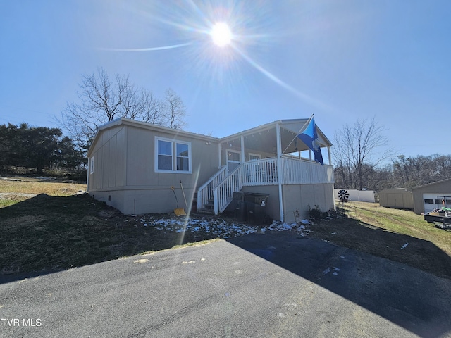 manufactured / mobile home featuring an outbuilding, crawl space, a shed, and stairs