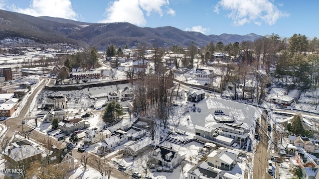 snowy aerial view with a residential view and a mountain view