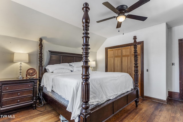 bedroom featuring baseboards, lofted ceiling, ceiling fan, dark wood-type flooring, and a closet