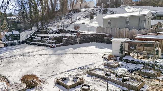 snowy yard with fence