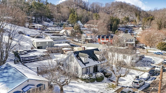 snowy aerial view with a residential view