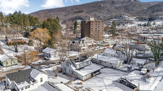 snowy aerial view featuring a mountain view