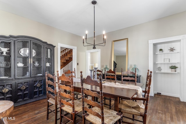 dining area featuring an inviting chandelier, baseboards, stairway, and dark wood finished floors