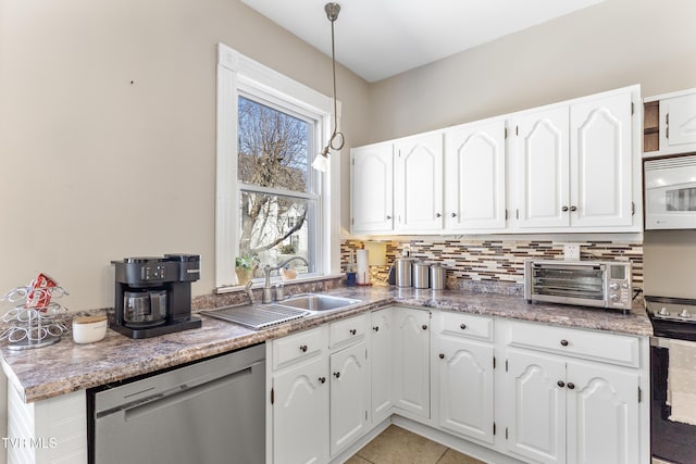 kitchen with white microwave, a toaster, white cabinets, stainless steel dishwasher, and decorative backsplash