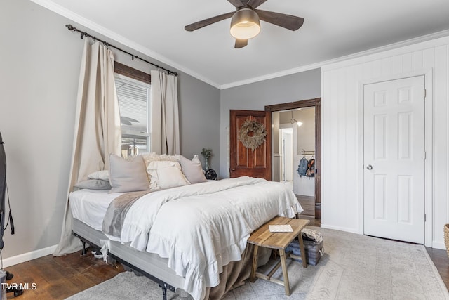 bedroom featuring ceiling fan, ornamental molding, dark wood finished floors, and baseboards