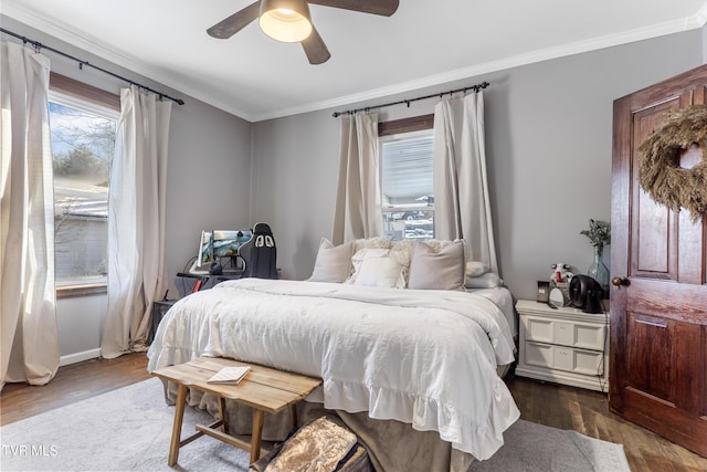 bedroom featuring crown molding, ceiling fan, and dark wood-type flooring