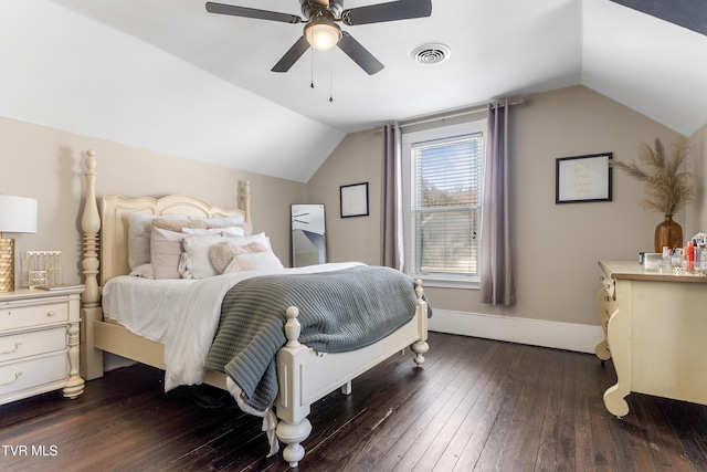 bedroom with lofted ceiling, dark wood finished floors, visible vents, and baseboards