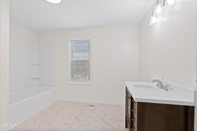 bathroom featuring marble finish floor, vanity, baseboards, and shower / bathtub combination