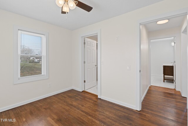 unfurnished bedroom featuring a ceiling fan, baseboards, and wood finished floors