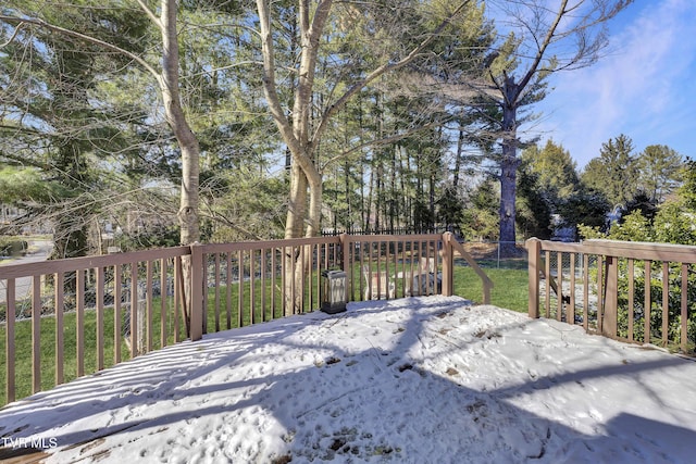 wooden deck featuring a lawn