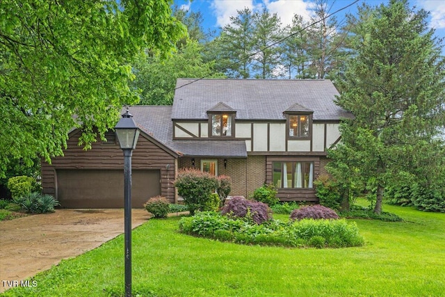 1016 Grace Dr, Johnson City, TN 37604 - tudor home with driveway, an attached garage, and a front yard