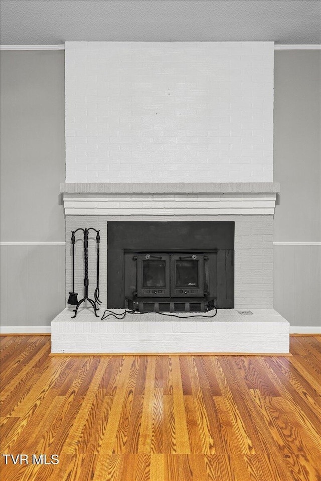 1016 Grace Dr, Johnson City, TN 37604 - detailed view of a fireplace, crown molding, wood finished floors, baseboards, and wainscoting