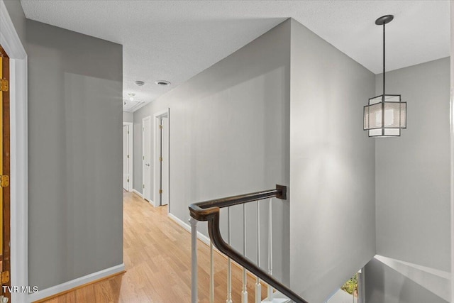 1016 Grace Dr, Johnson City, TN 37604 - corridor featuring an upstairs landing, light wood-type flooring, baseboards, and a textured ceiling