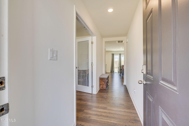 corridor with recessed lighting, visible vents, baseboards, and wood finished floors