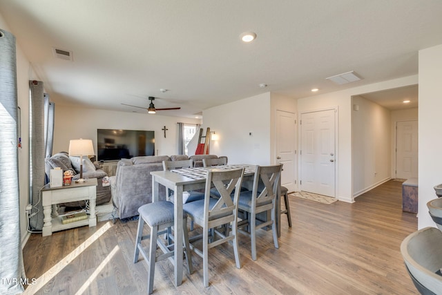 dining area with a ceiling fan, recessed lighting, visible vents, and wood finished floors