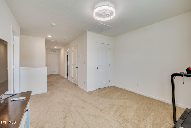 interior space with carpet floors, attic access, and baseboards