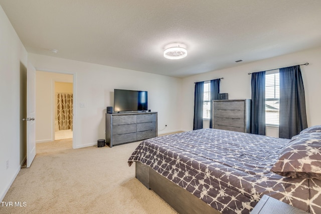 carpeted bedroom featuring a textured ceiling and baseboards