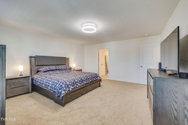 bedroom with a textured ceiling, carpet floors, and baseboards