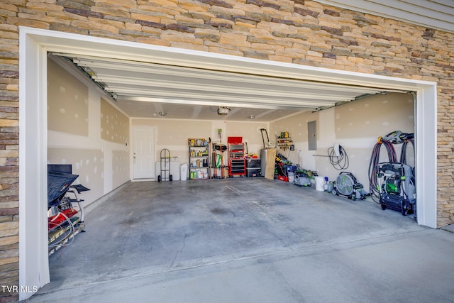 garage featuring electric panel and a garage door opener