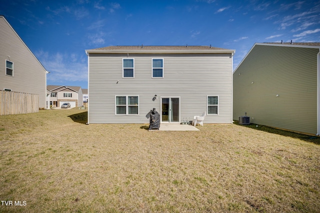 rear view of house with a patio, central AC unit, and a lawn