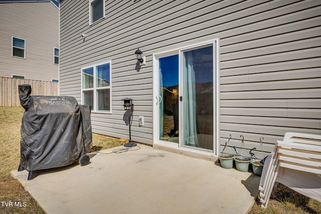 view of patio with a grill and fence