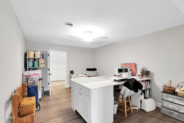 office area featuring light wood-style floors, visible vents, and baseboards