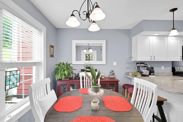 dining area with an inviting chandelier