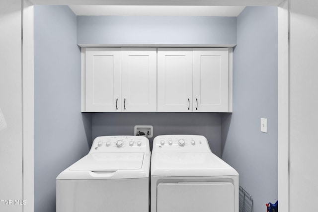 laundry room with washer and dryer and cabinet space