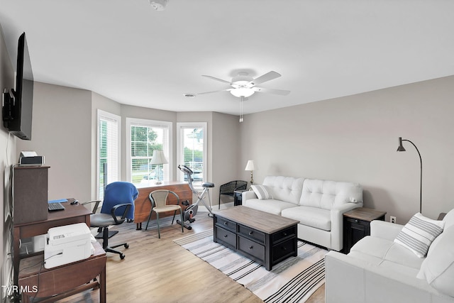 living room featuring light wood-style floors and ceiling fan