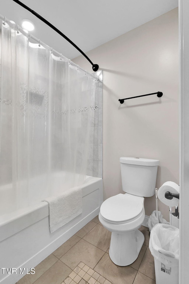 bathroom featuring tile patterned flooring, shower / tub combo, and toilet