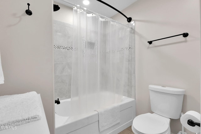 bathroom featuring toilet and shower / bath combo with shower curtain