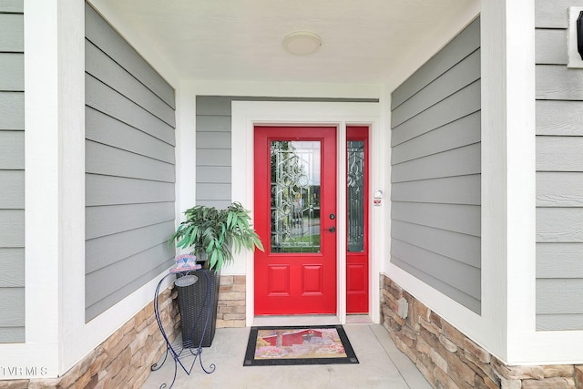 doorway to property with stone siding