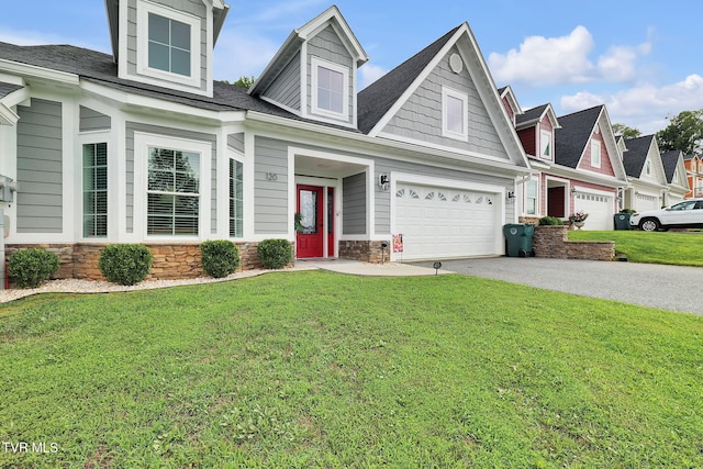 cape cod-style house featuring driveway, stone siding, an attached garage, and a front yard