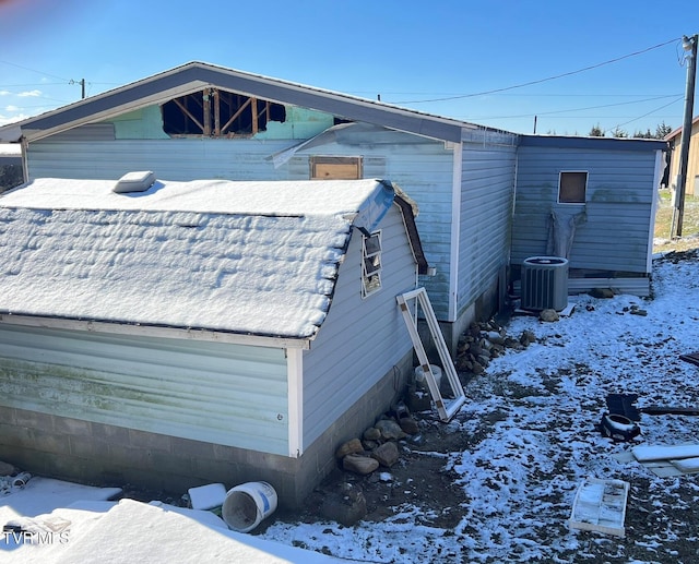 view of snowy exterior with central AC