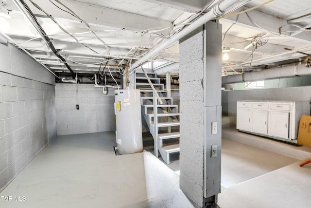 unfinished basement featuring water heater