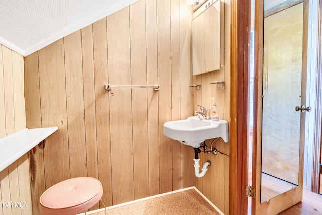 half bathroom with wood walls and toilet